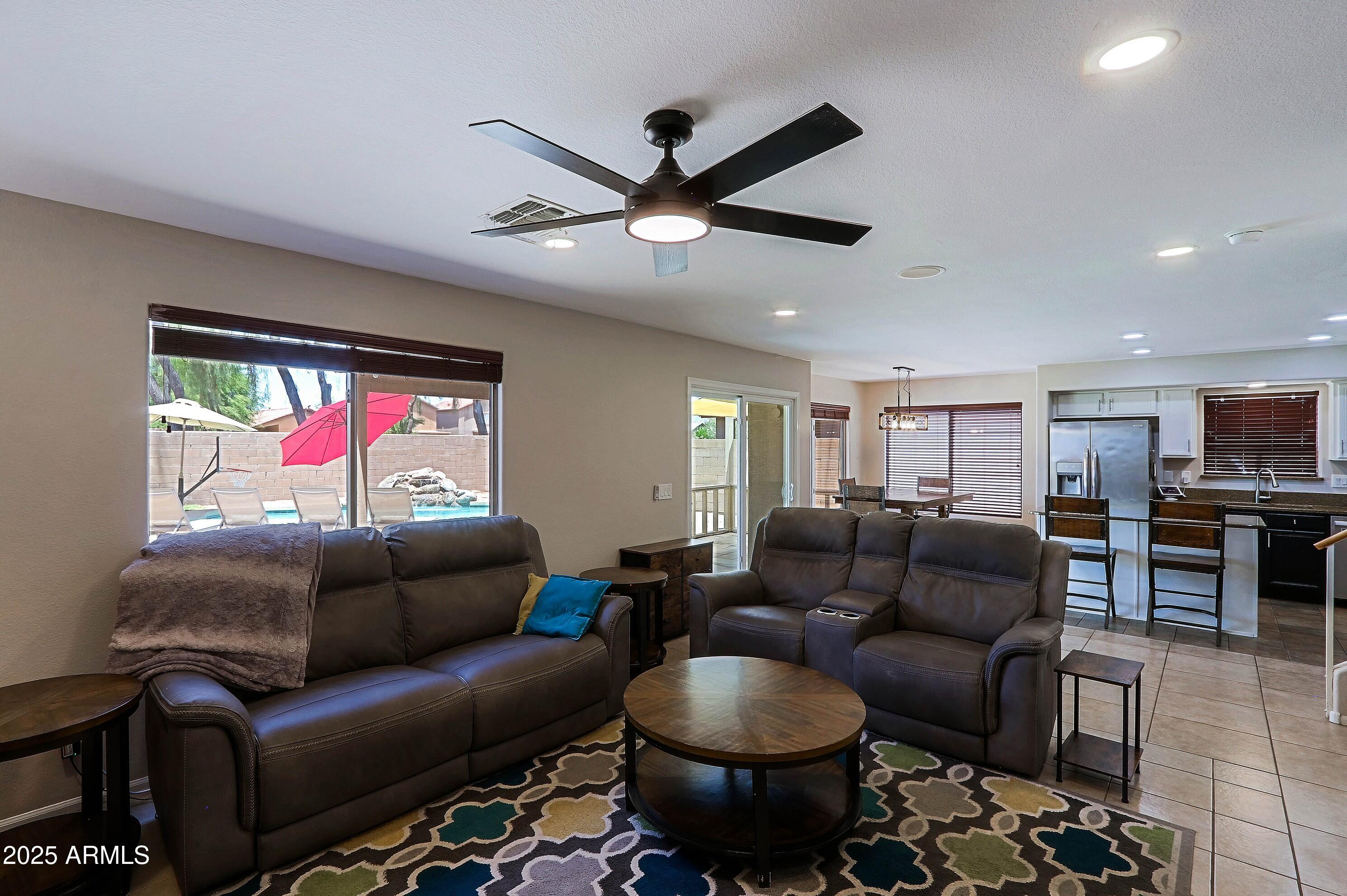 42812 West Venture Road Maricopa, AZ 85138 - Photo 20 of 58 a living room with furniture a ceiling fan and a rug