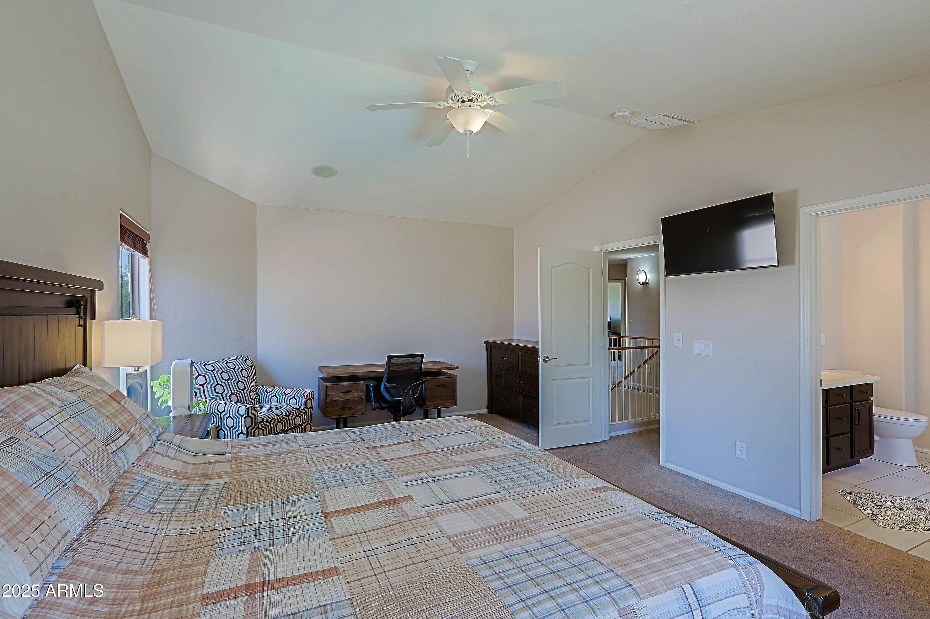 42812 West Venture Road Maricopa, AZ 85138 - Photo 36 of 58 a bedroom with a bed and a television