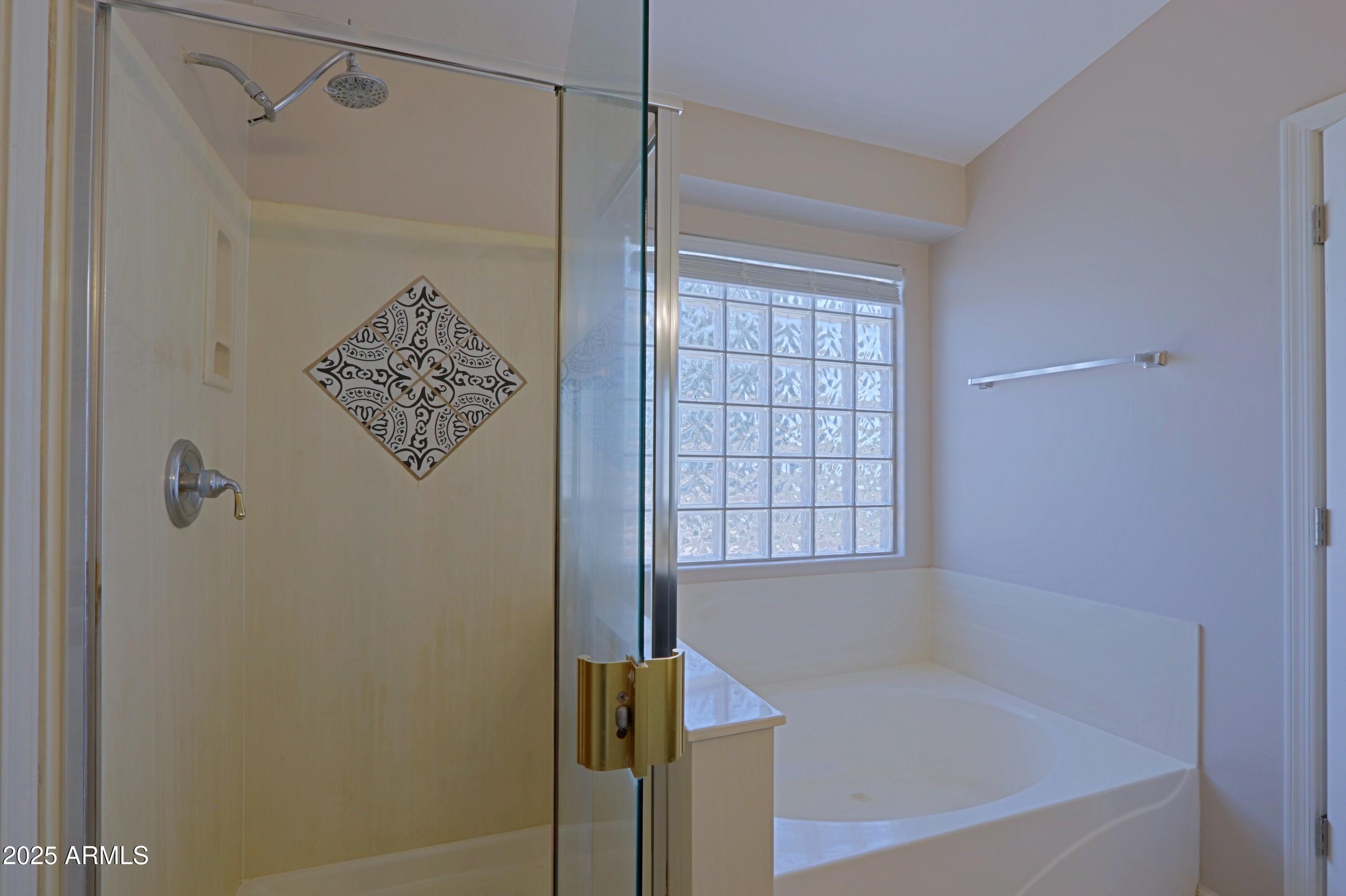 42812 West Venture Road Maricopa, AZ 85138 - Photo 42 of 58 a bathroom with a bathtub and shower
