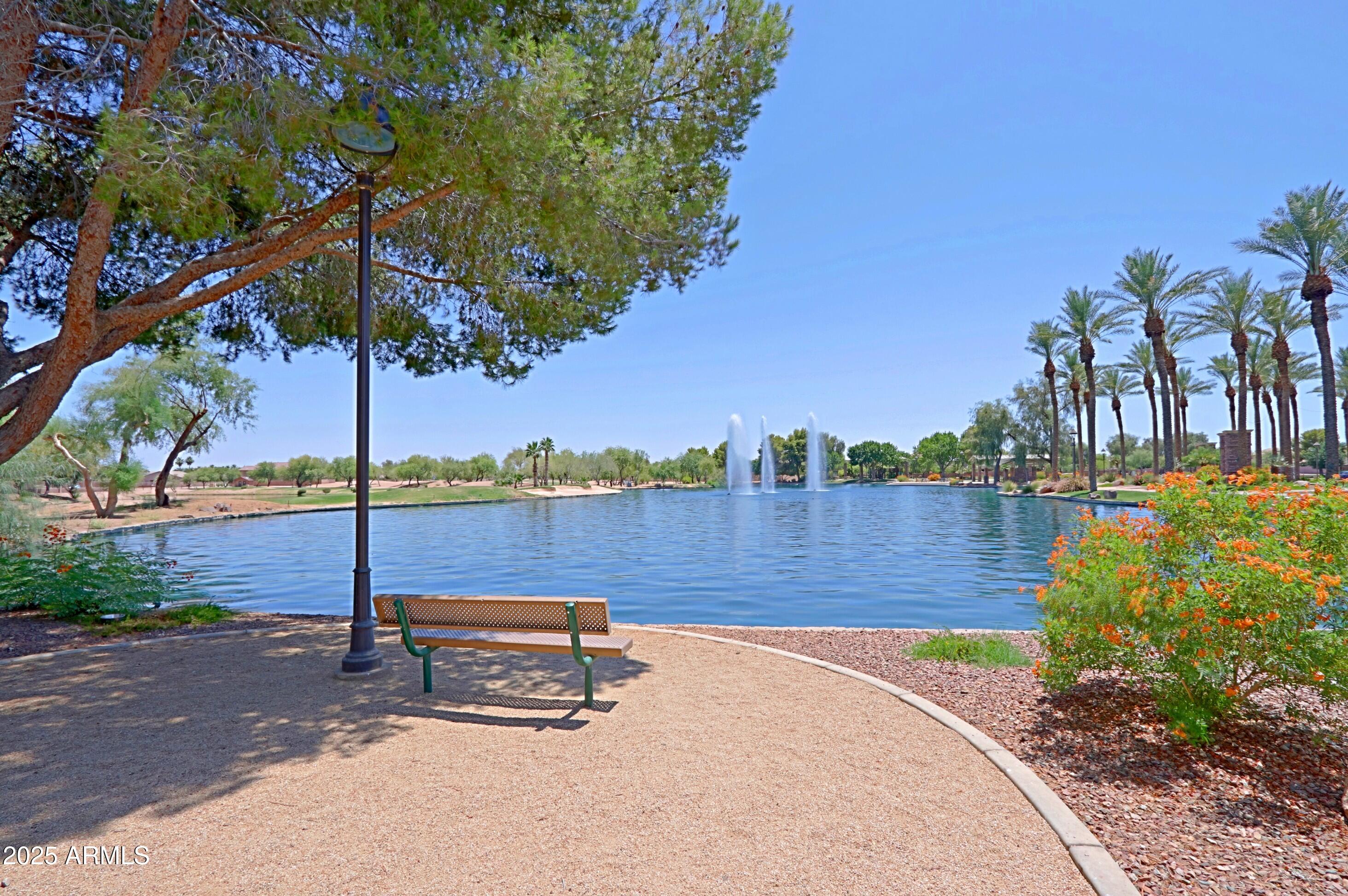 42812 West Venture Road Maricopa, AZ 85138 - Photo 55 of 58 a view of a bench in a yard next to a lake