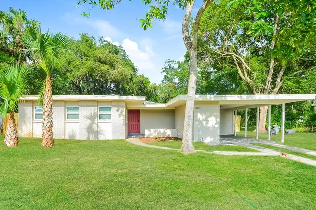 a front view of house with yard and green space