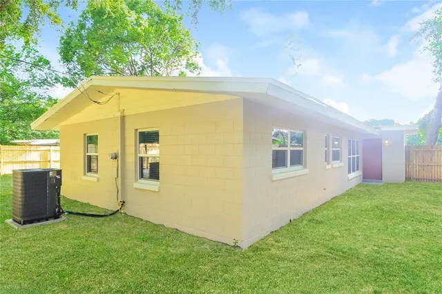 a view of backyard with barbeque grill and a small yard