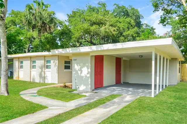 a view of a house with a yard porch and sitting area