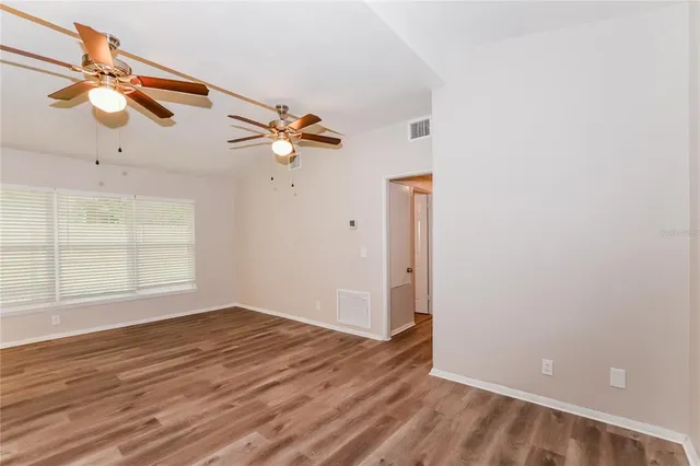 wooden floor in an empty room with a window