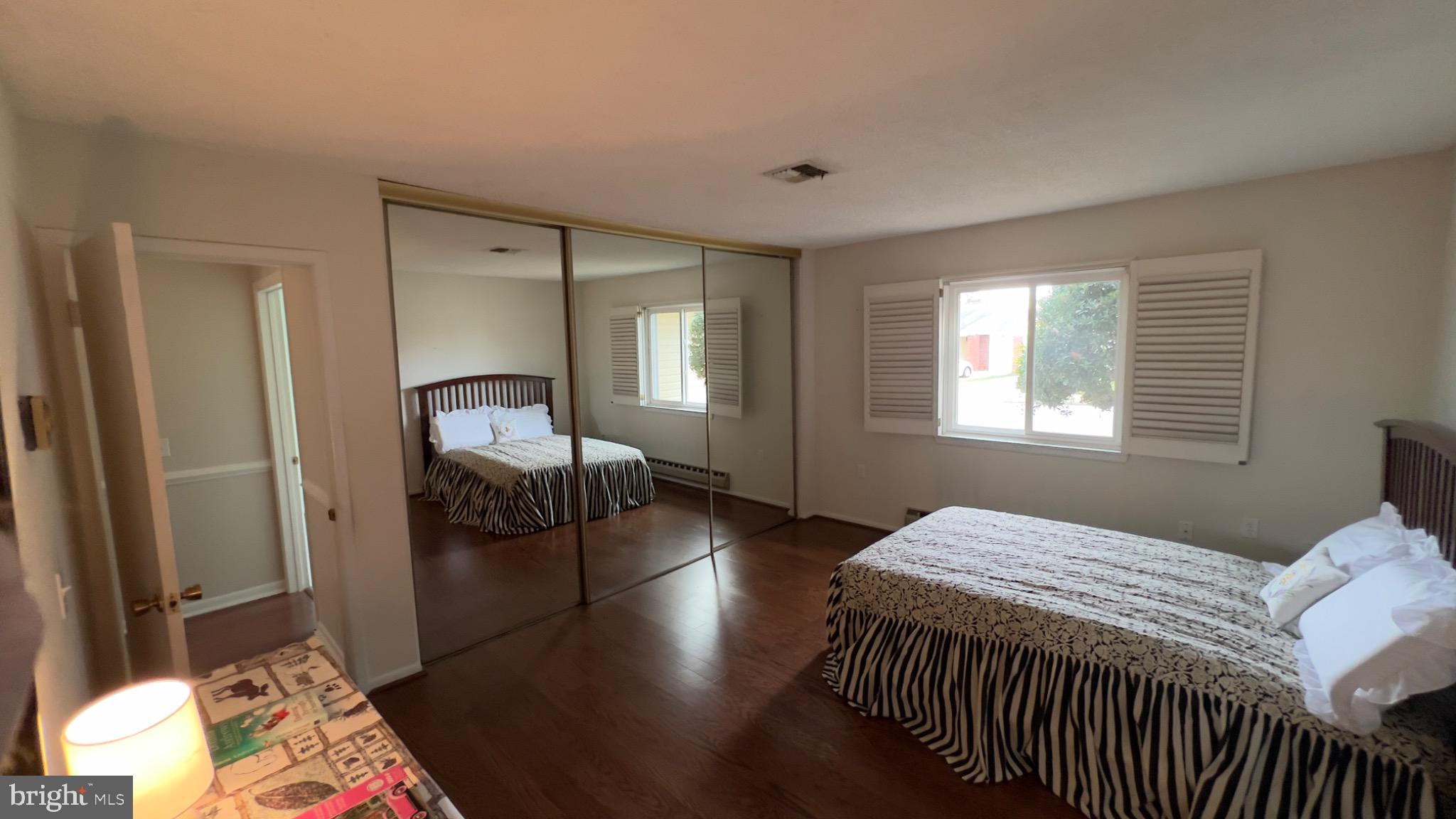 3525 Tarkington Lane, Unit 63B Silver Spring, MD 20906 - Photo 16 of 36 a bedroom with a bed and wooden floor