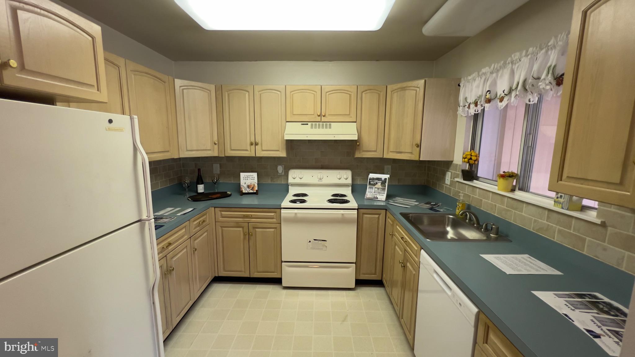 3525 Tarkington Lane, Unit 63B Silver Spring, MD 20906 - Photo 17 of 36 a kitchen with a sink stove and refrigerator