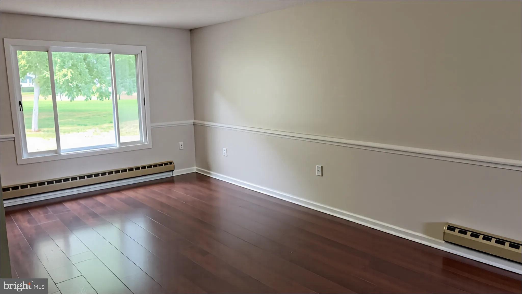 3525 Tarkington Lane, Unit 63B Silver Spring, MD 20906 - Photo 2 of 36 an empty room with wooden floor and windows