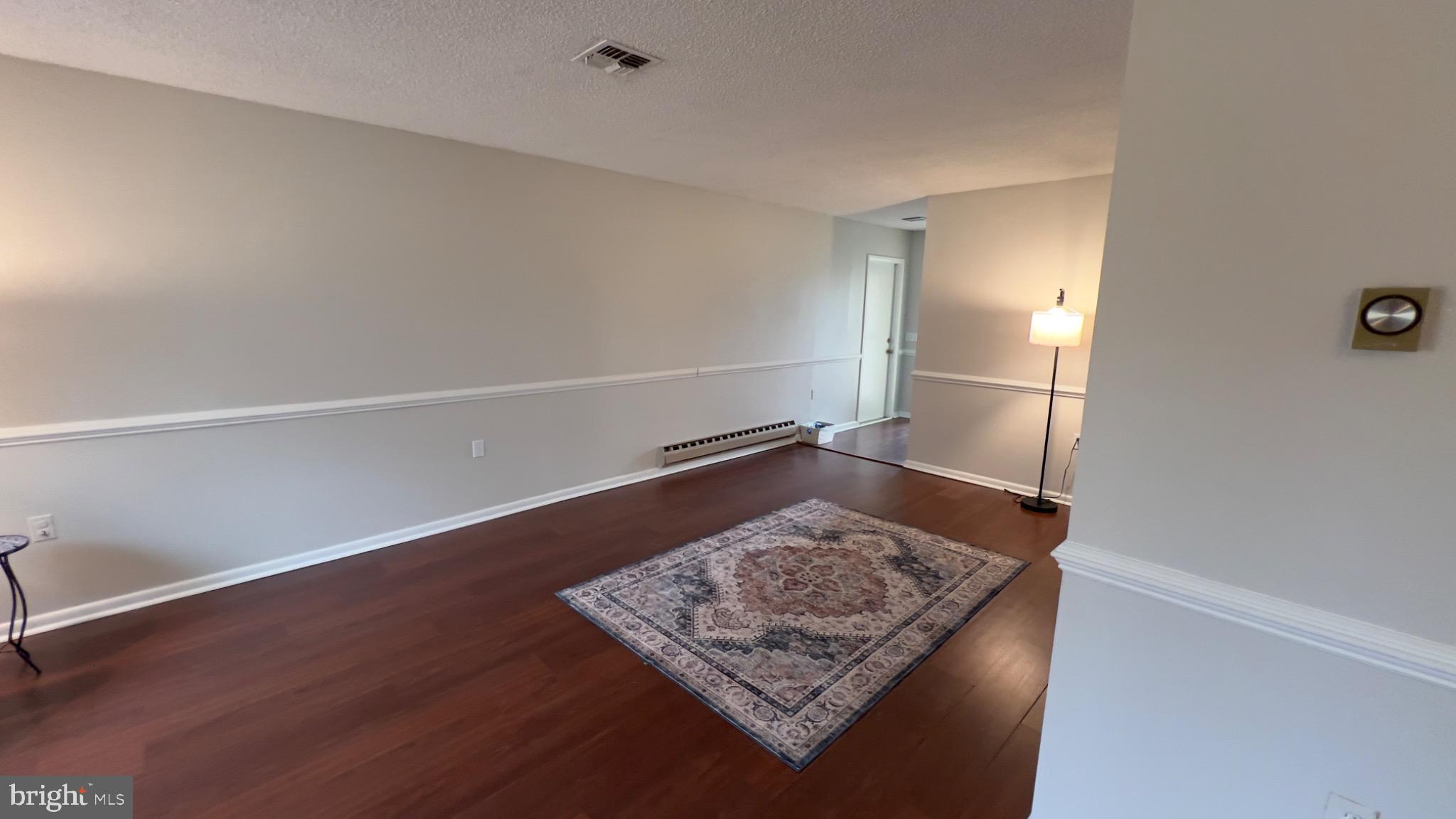 3525 Tarkington Lane, Unit 63B Silver Spring, MD 20906 - Photo 21 of 36 an empty room with wooden floor and window