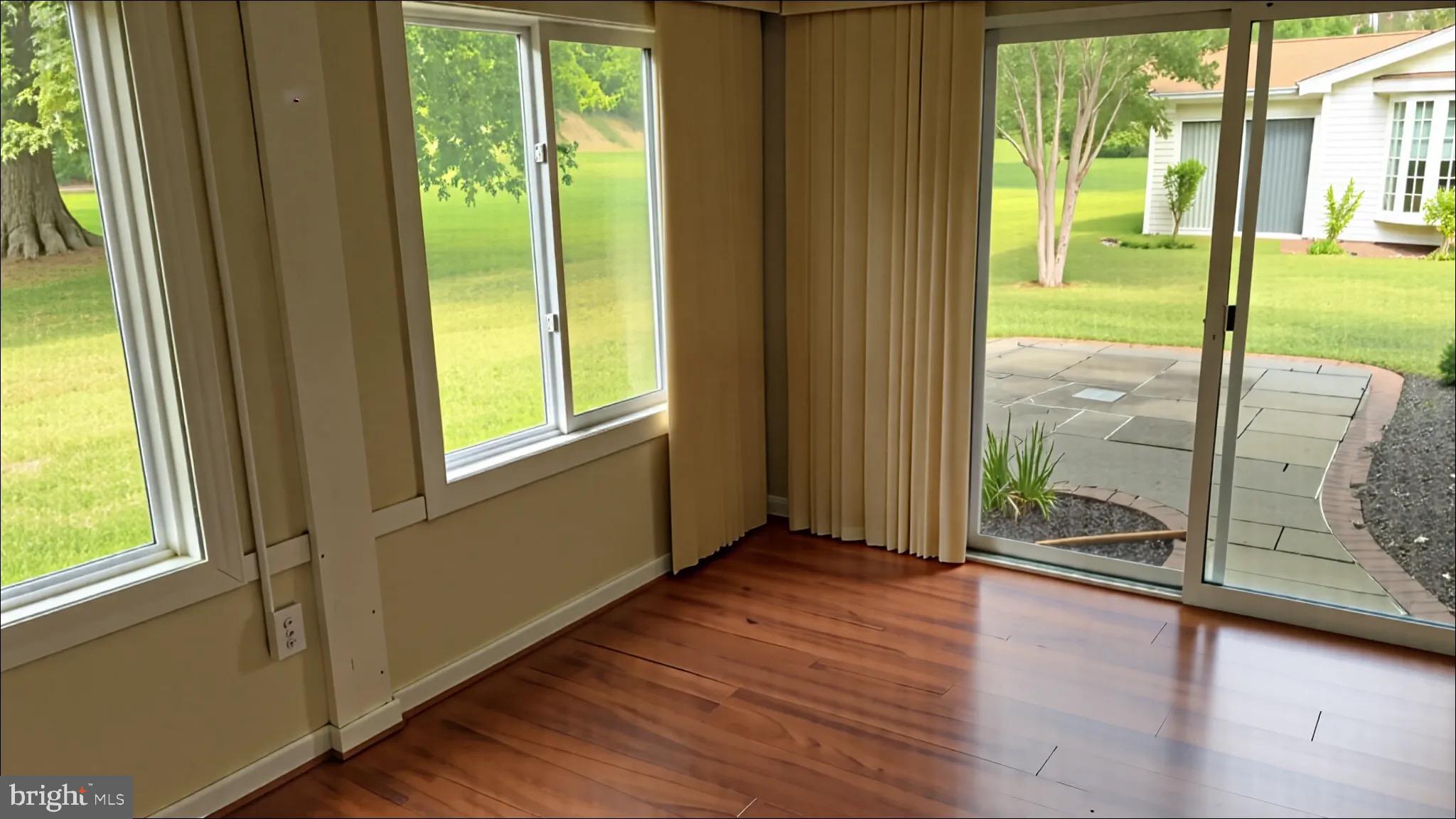 3525 Tarkington Lane, Unit 63B Silver Spring, MD 20906 - Photo 3 of 36 a view of an empty room with wooden floor and doors