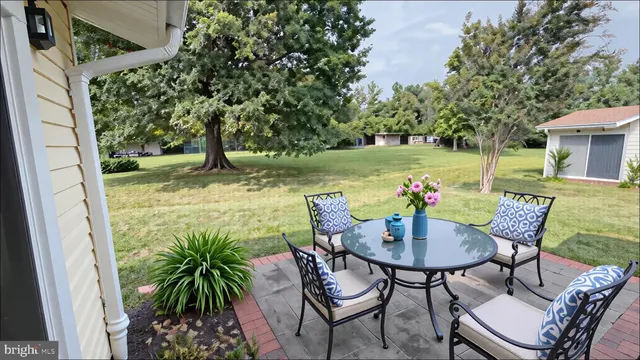 a view of a chairs and table in patio