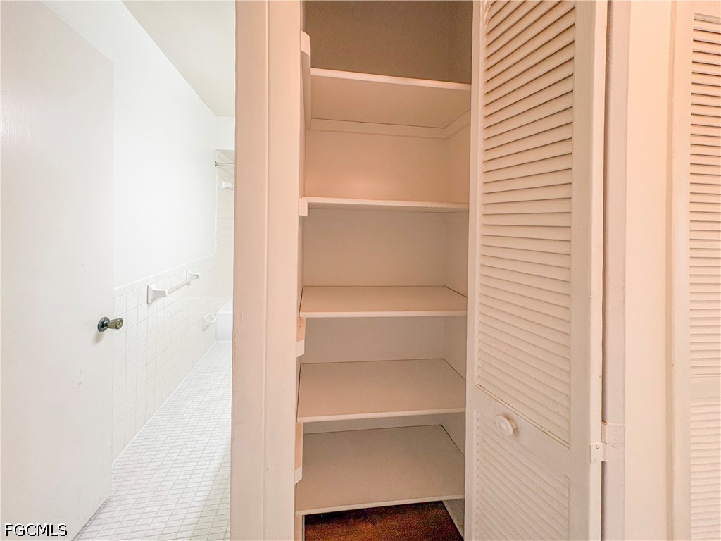 1830 Brantley Road, Unit I7 Fort Myers, FL 33907 - Photo 24 of 34 a view of walk in closet with empty racks
