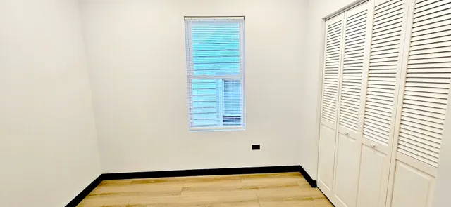 a view of an empty room with a window