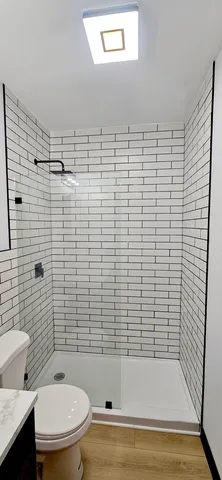 a bathroom with a toilet and a shower
