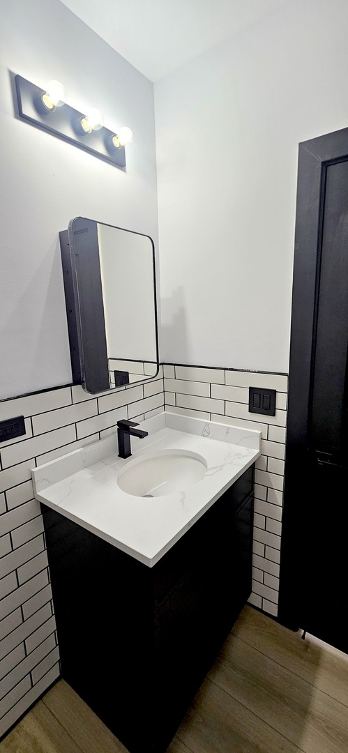 1833 West 21st Street, Unit 2R Chicago, IL 60608 - Photo 7 of 14 a bathroom with a sink and a mirror