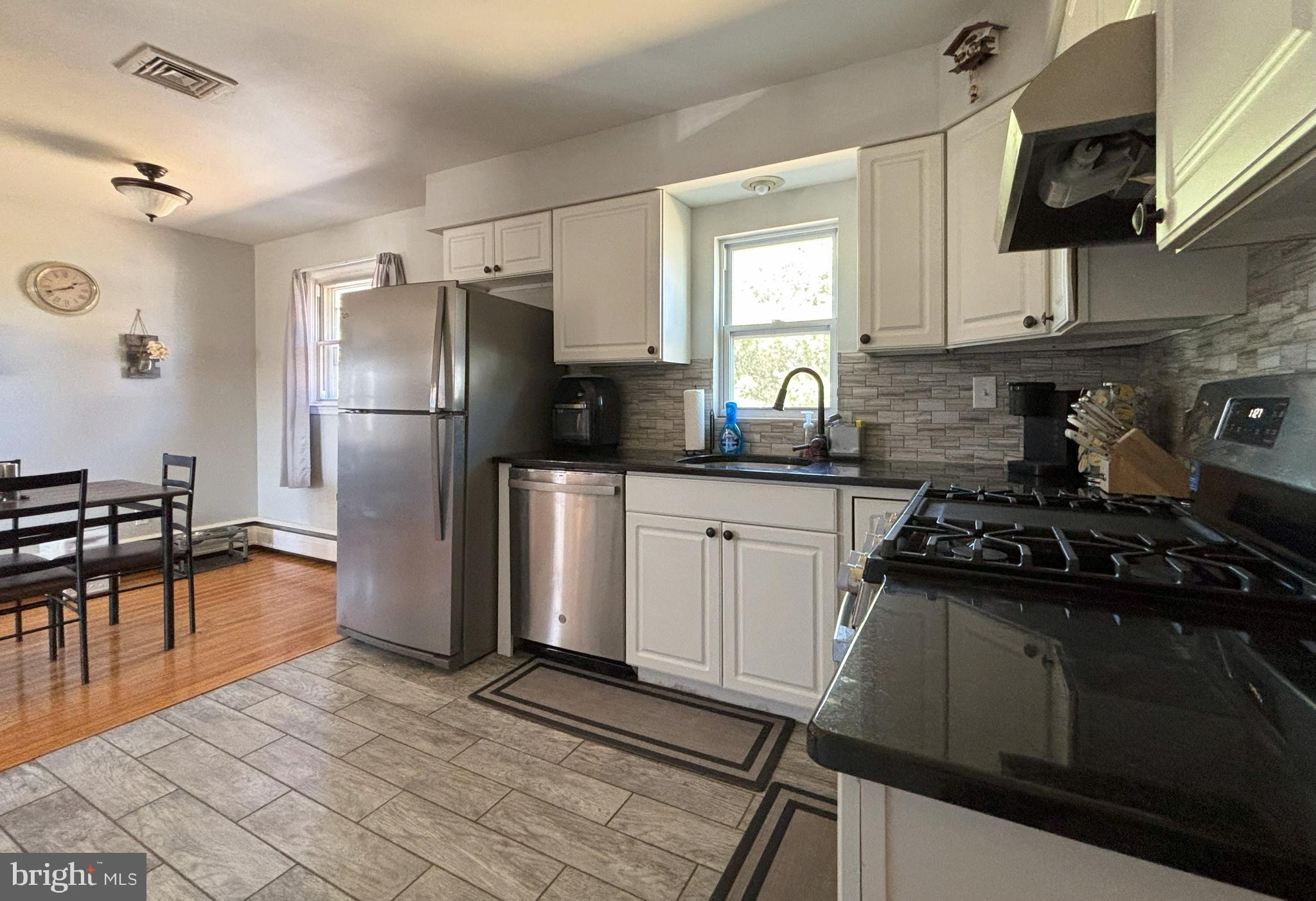 205 Lucas Avenue West Berlin, NJ 08091 - Photo 13 of 25 a kitchen with stainless steel appliances a sink stove refrigerator and cabinets