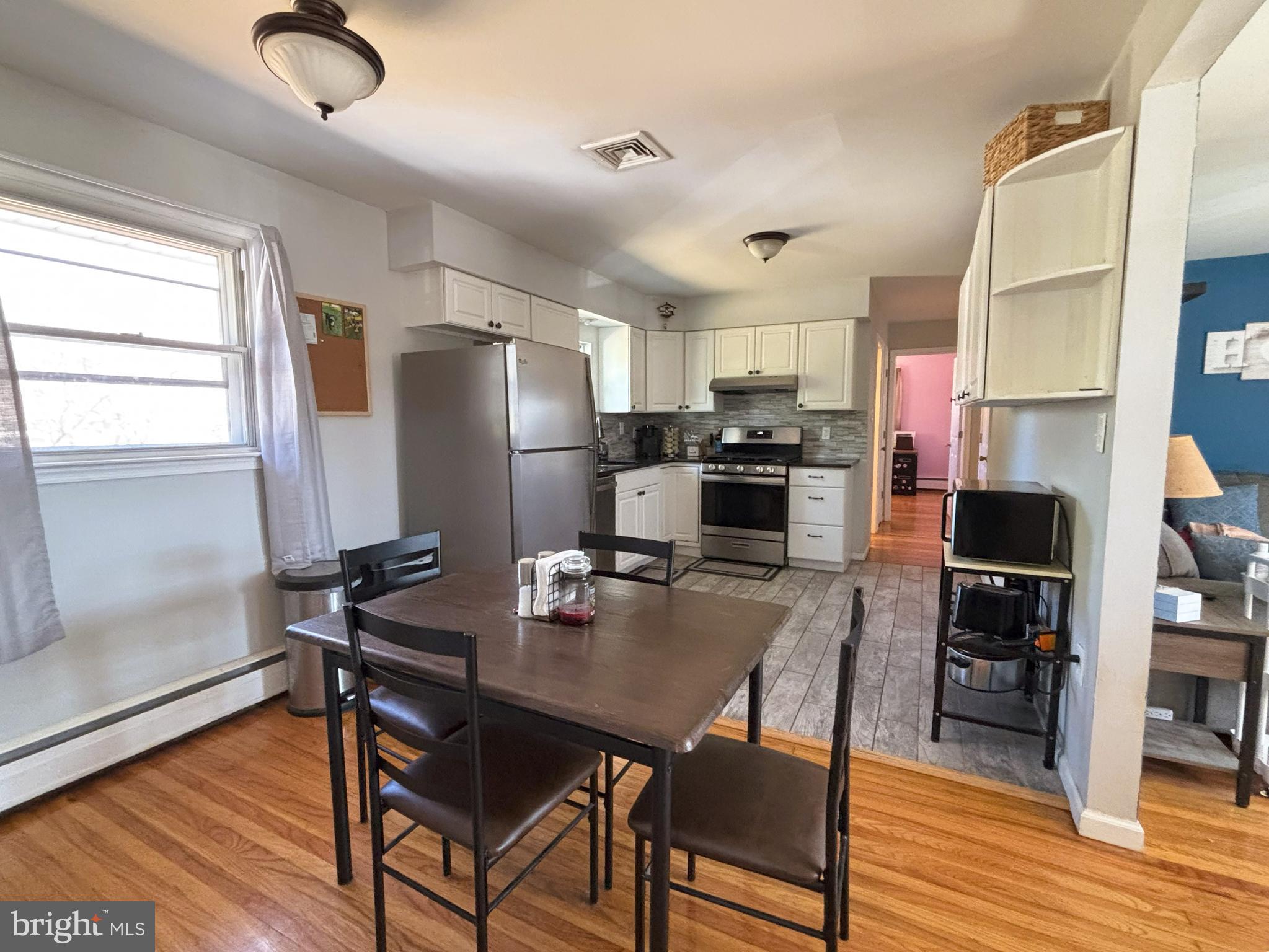 205 Lucas Avenue West Berlin, NJ 08091 - Photo 10 of 25 a kitchen with stainless steel appliances granite countertop a dining table chairs refrigerator and sink