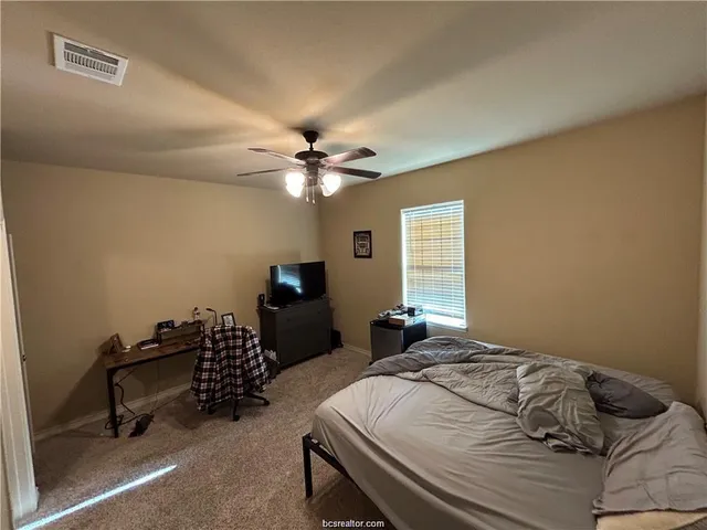 a bedroom with bed and a window