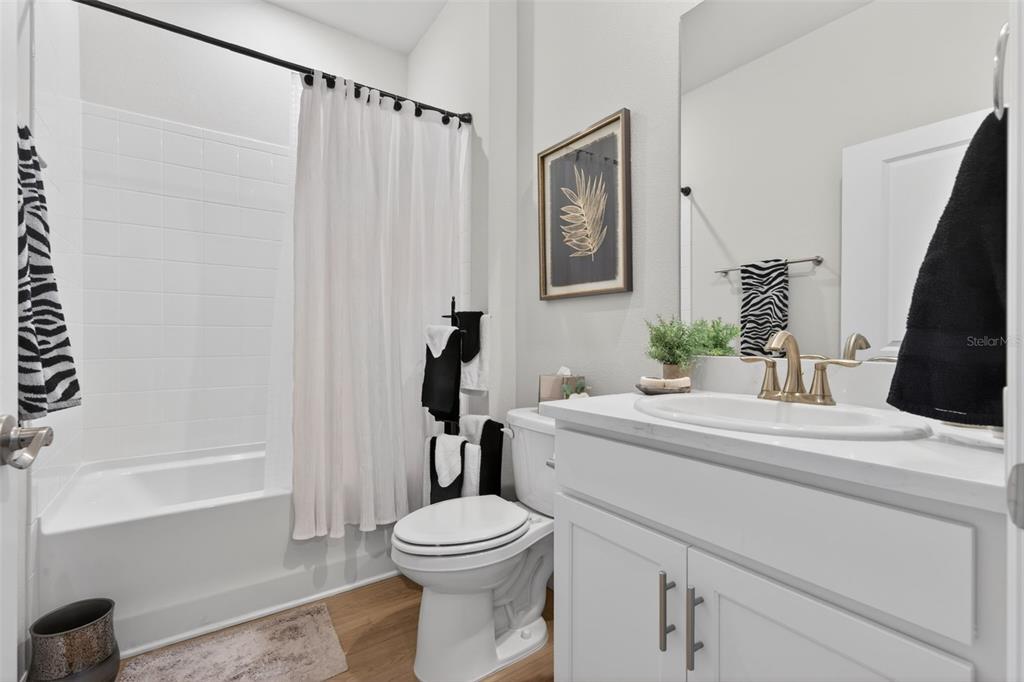 18237 Beach Ranch Terrace Bradenton, FL 34211 - Photo 24 of 72 a bathroom with a sink a toilet and shower