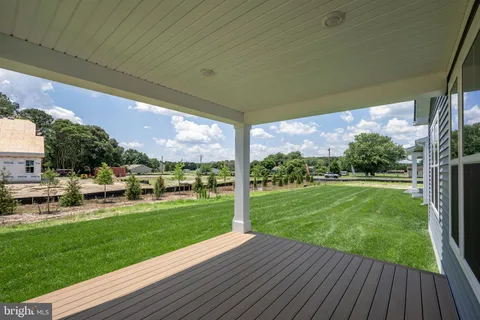 a view of a porch with furniture and garden