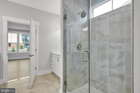 a bathroom with a shower and a sink