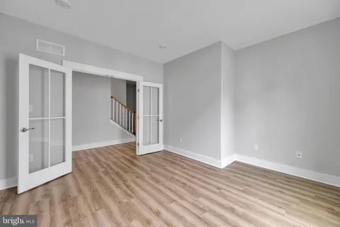 a view of an empty room with wooden floor