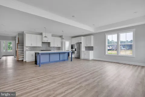 a view of kitchen with wooden floor and electronic appliances