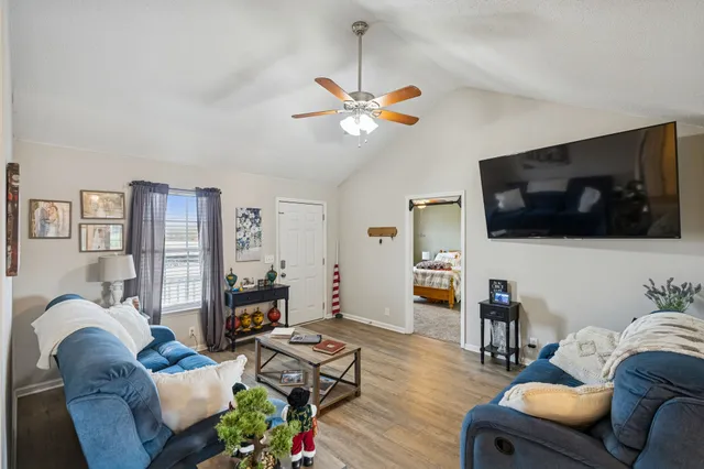a living room with furniture and wooden floor