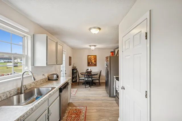 a stove top oven sitting inside of a kitchen
