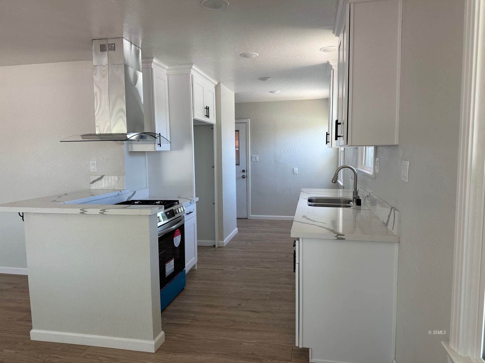 300 North Sanders Street Ridgecrest, CA 93555 - Photo 5 of 15 a kitchen with a sink a stove and a refrigerator