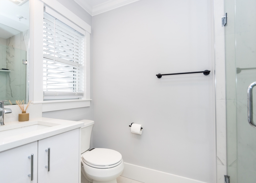 29 Cherry Street, Unit 2 Waltham, MA 02453 - Photo 16 of 32 a bathroom with a sink a toilet and shower
