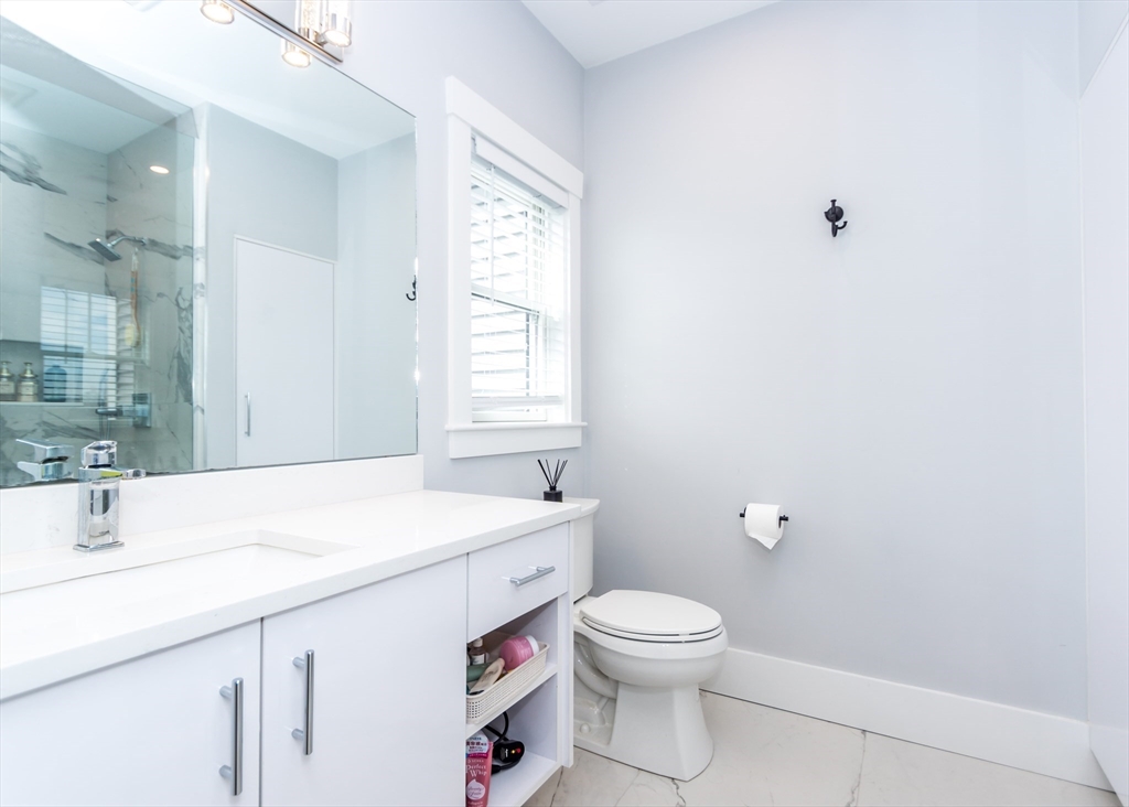 29 Cherry Street, Unit 2 Waltham, MA 02453 - Photo 18 of 32 a bathroom with a sink a toilet and a window