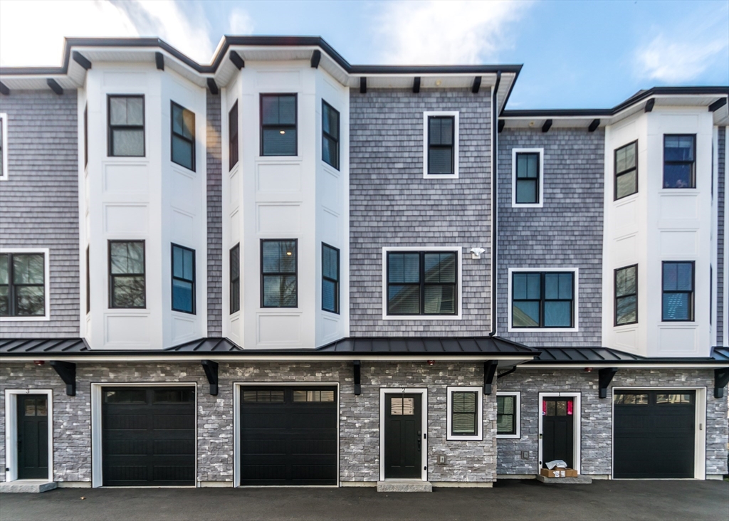 29 Cherry Street, Unit 2 Waltham, MA 02453 - Photo 2 of 32 a front view of a building with many windows