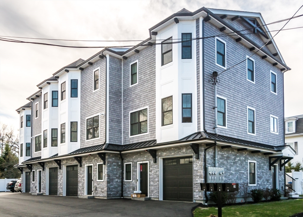 29 Cherry Street, Unit 2 Waltham, MA 02453 - Photo 3 of 32 a front view of a building with a yard