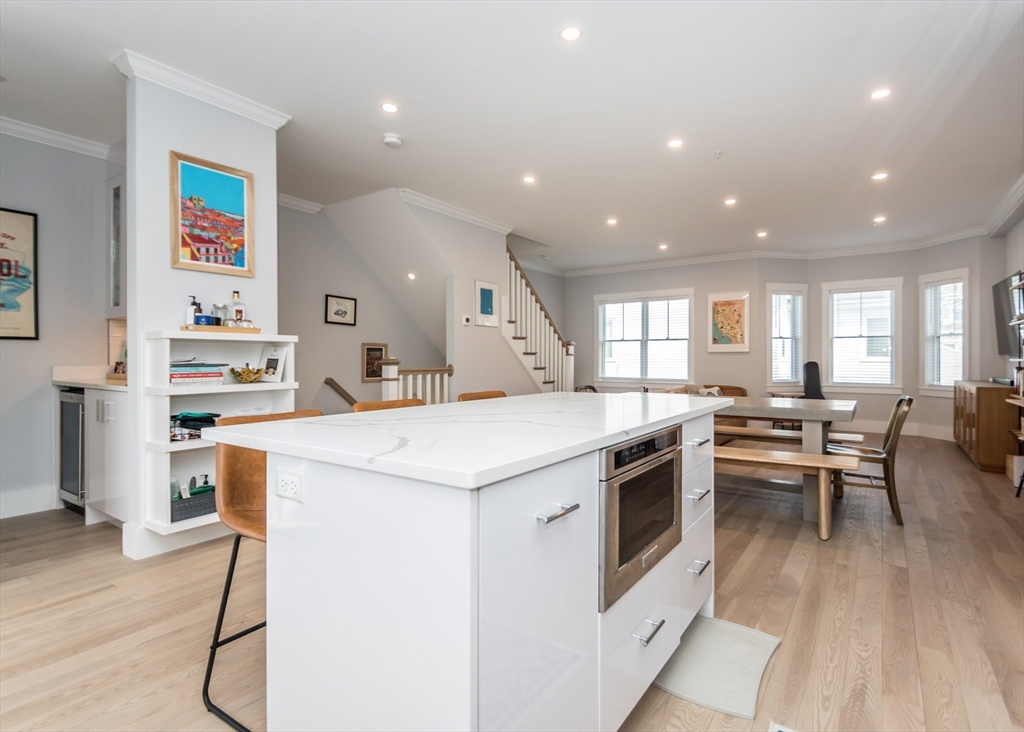 29 Cherry Street, Unit 2 Waltham, MA 02453 - Photo 7 of 32 a kitchen with a sink and wooden floor