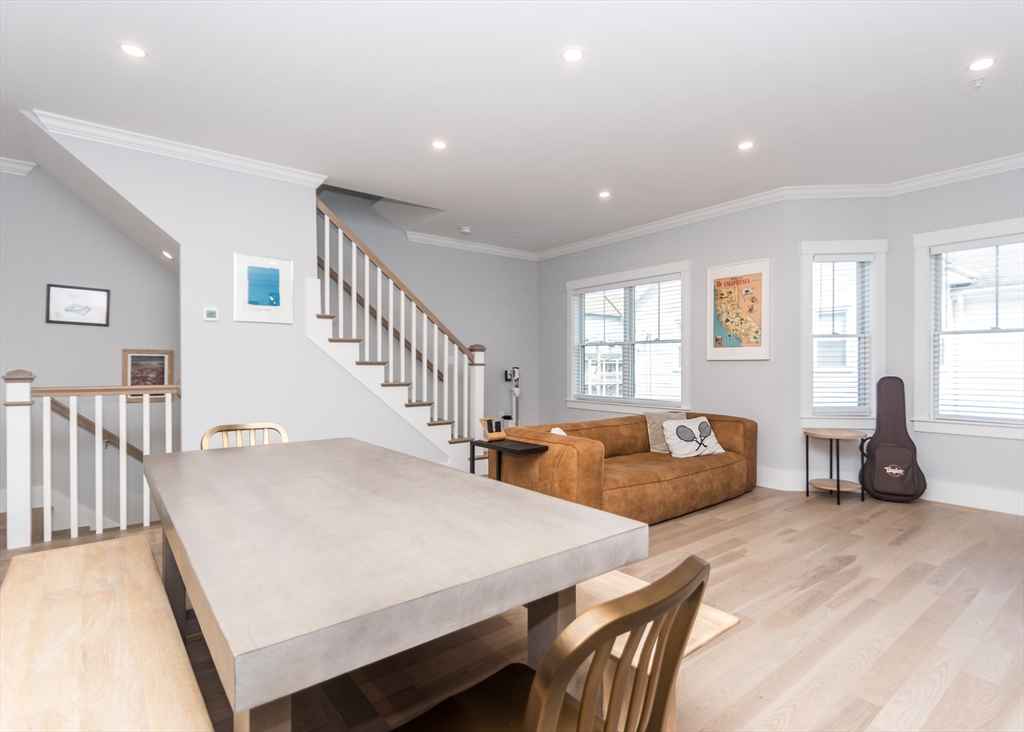 29 Cherry Street, Unit 2 Waltham, MA 02453 - Photo 8 of 32 a living room with furniture a large window and wooden floor