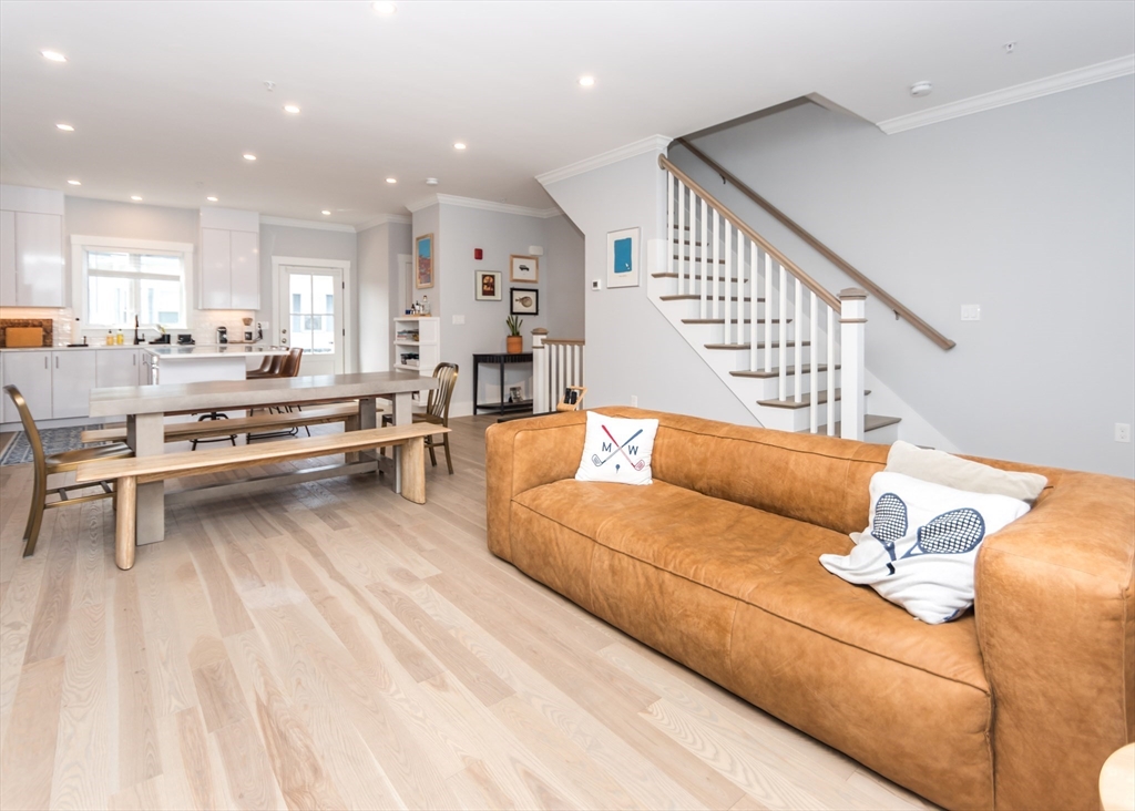 29 Cherry Street, Unit 2 Waltham, MA 02453 - Photo 10 of 32 a living room with furniture kitchen view and a wooden floor