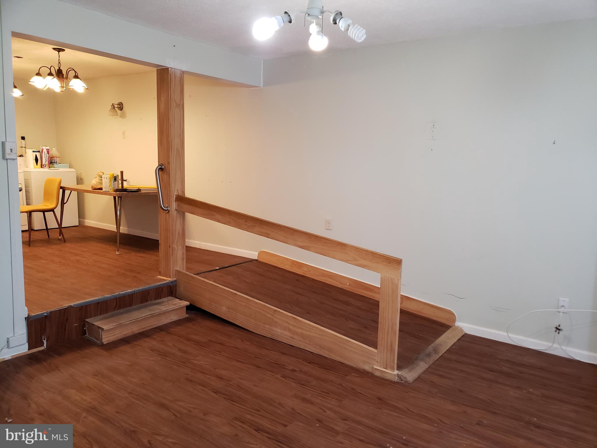 1762 Melbourne Road Baltimore, MD 21222 - Photo 3 of 40 an empty room with wooden floor and windows