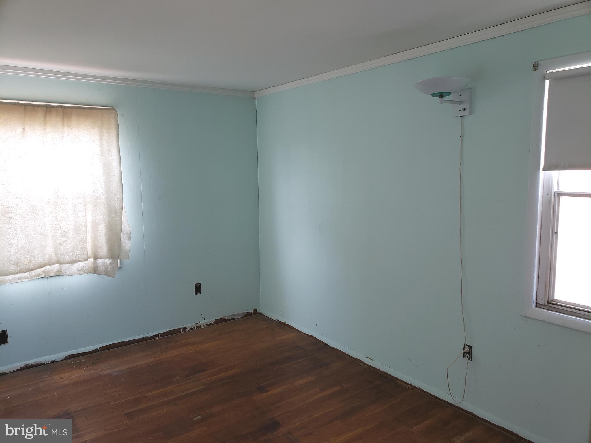 1762 Melbourne Road Baltimore, MD 21222 - Photo 22 of 40 an empty room with wooden floor and windows