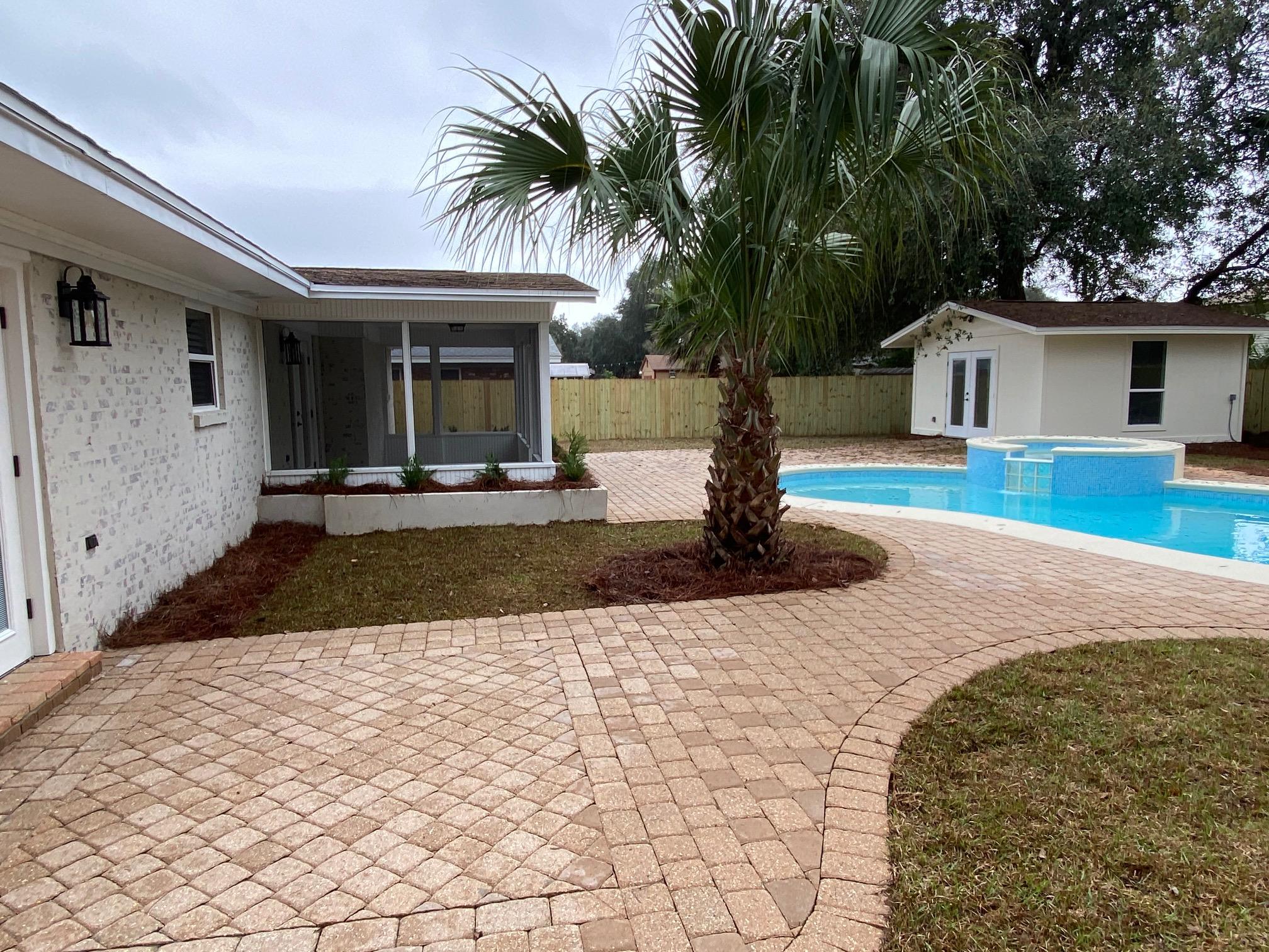 321 St Andrews Drive Niceville, FL 32578 - Photo 12 of 15 a front view of a house with a yard and potted plants