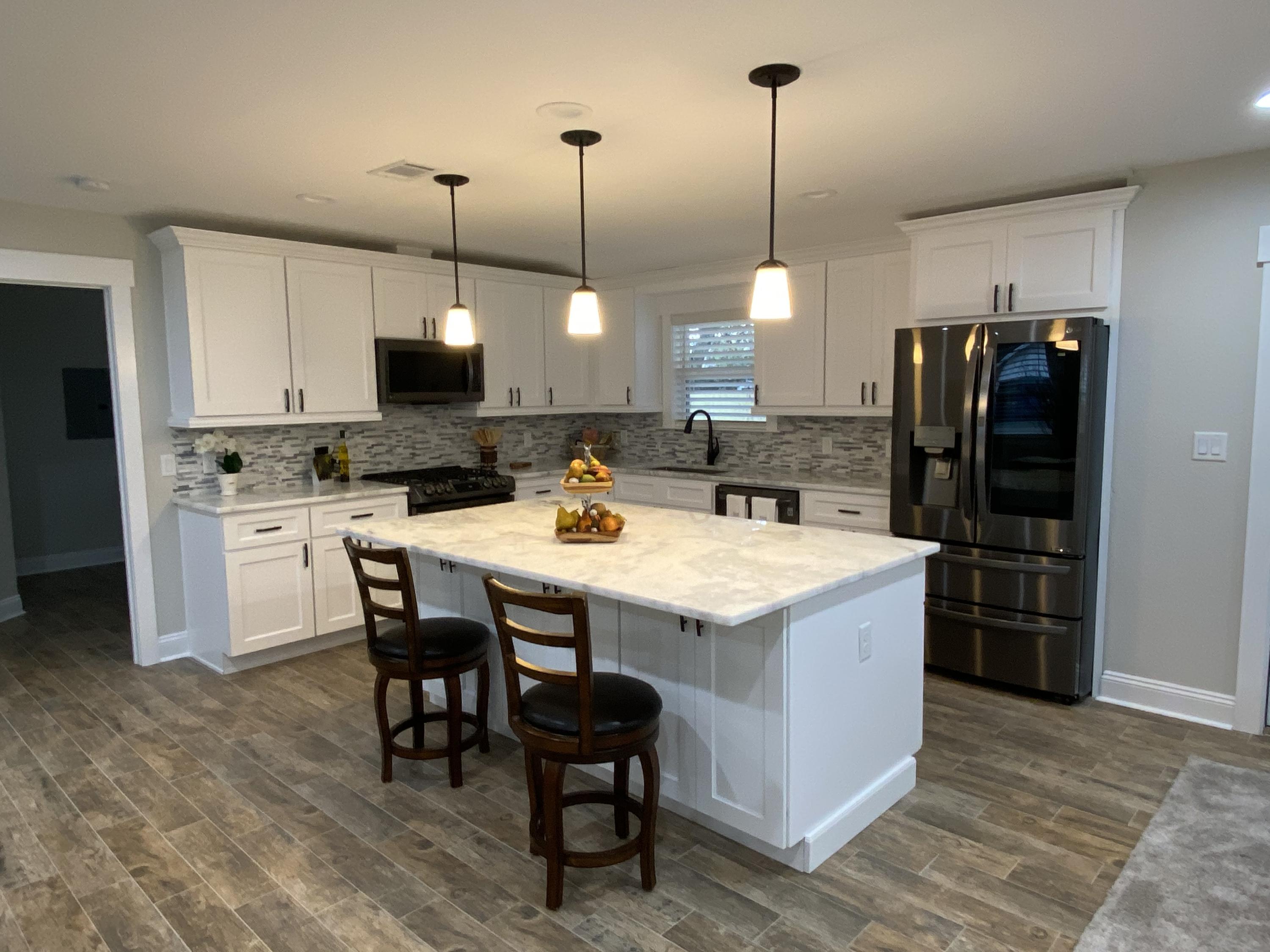 321 St Andrews Drive Niceville, FL 32578 - Photo 4 of 15 a kitchen with stainless steel appliances microwave stove refrigerator and wooden floor