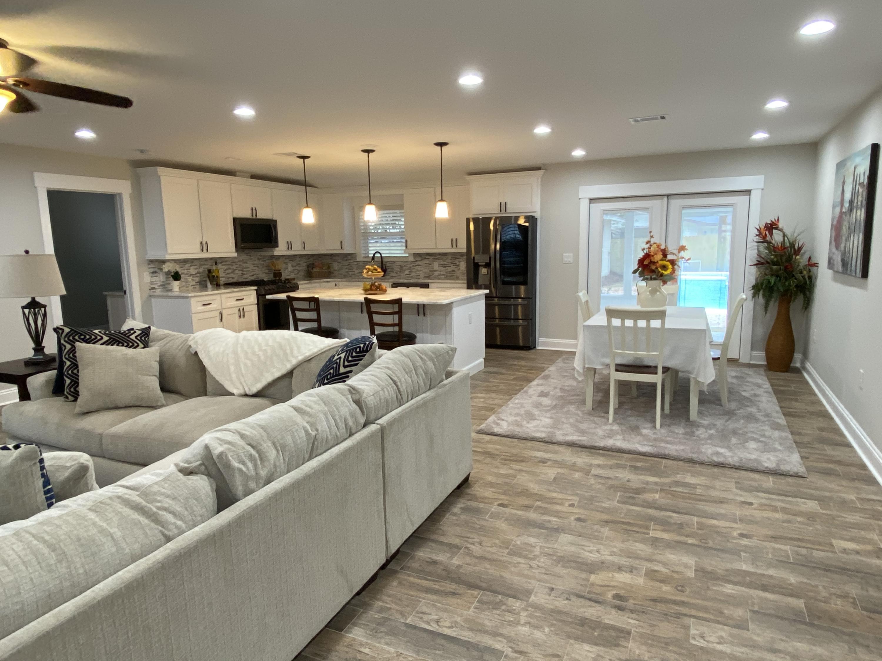 321 St Andrews Drive Niceville, FL 32578 - Photo 5 of 15 a living room with furniture kitchen view and a large window