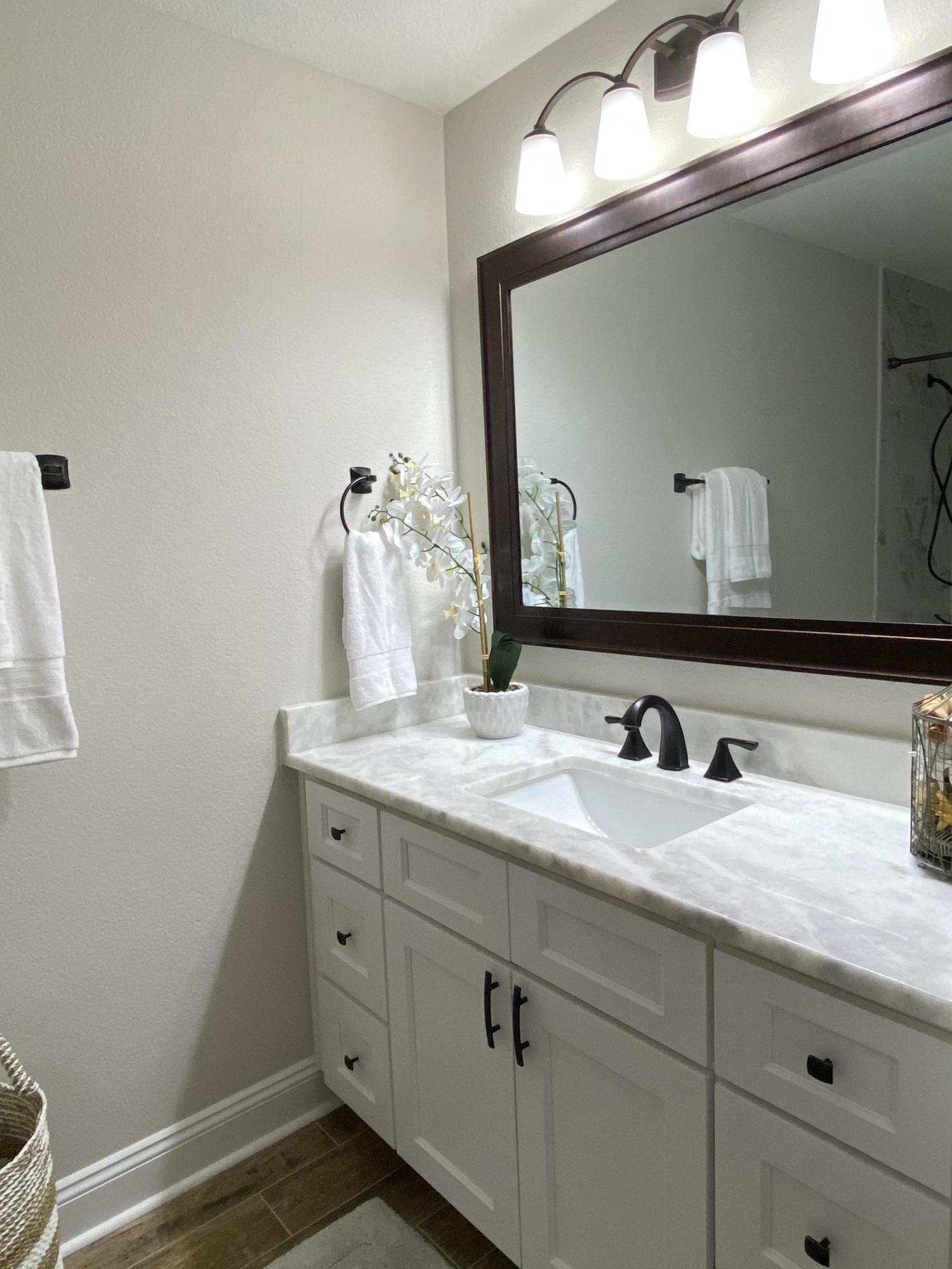 321 St Andrews Drive Niceville, FL 32578 - Photo 9 of 15 a bathroom with a granite countertop sink and a mirror