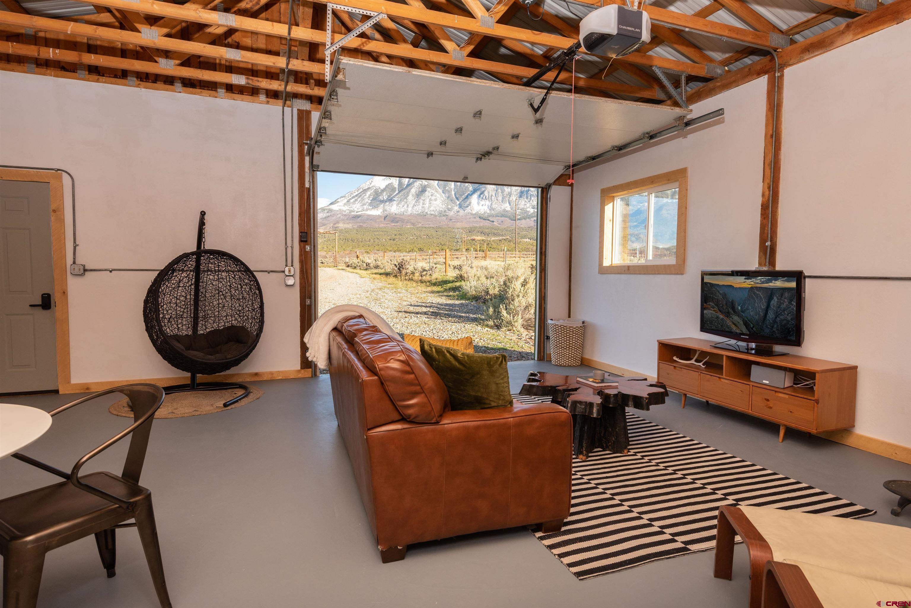 11531 4050th Road Paonia, CO 81428 - Photo 12 of 37 a living room with furniture a flat screen tv and a window