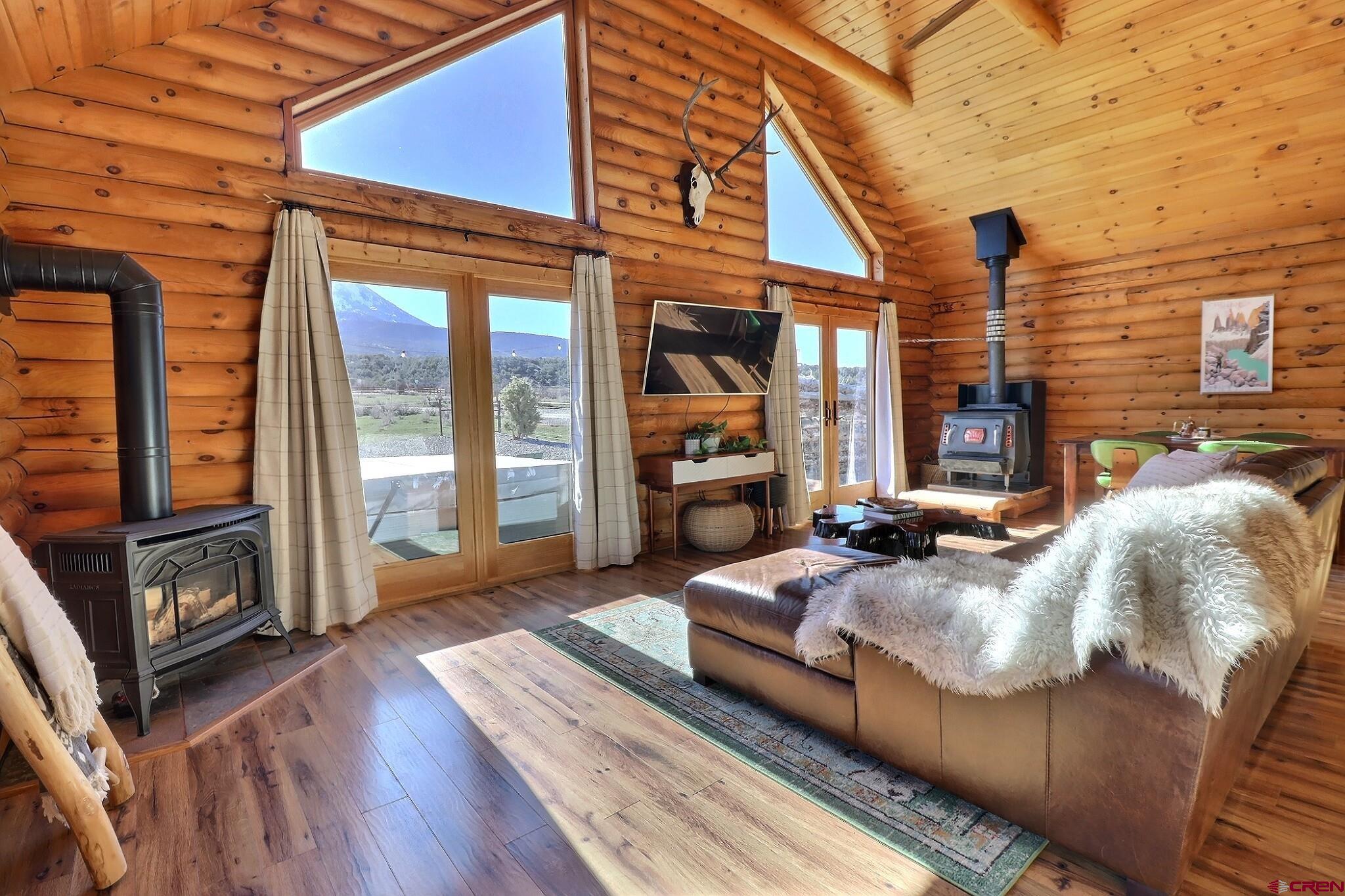 11531 4050th Road Paonia, CO 81428 - Photo 23 of 37 a view of a patio with couches chairs and wooden floor