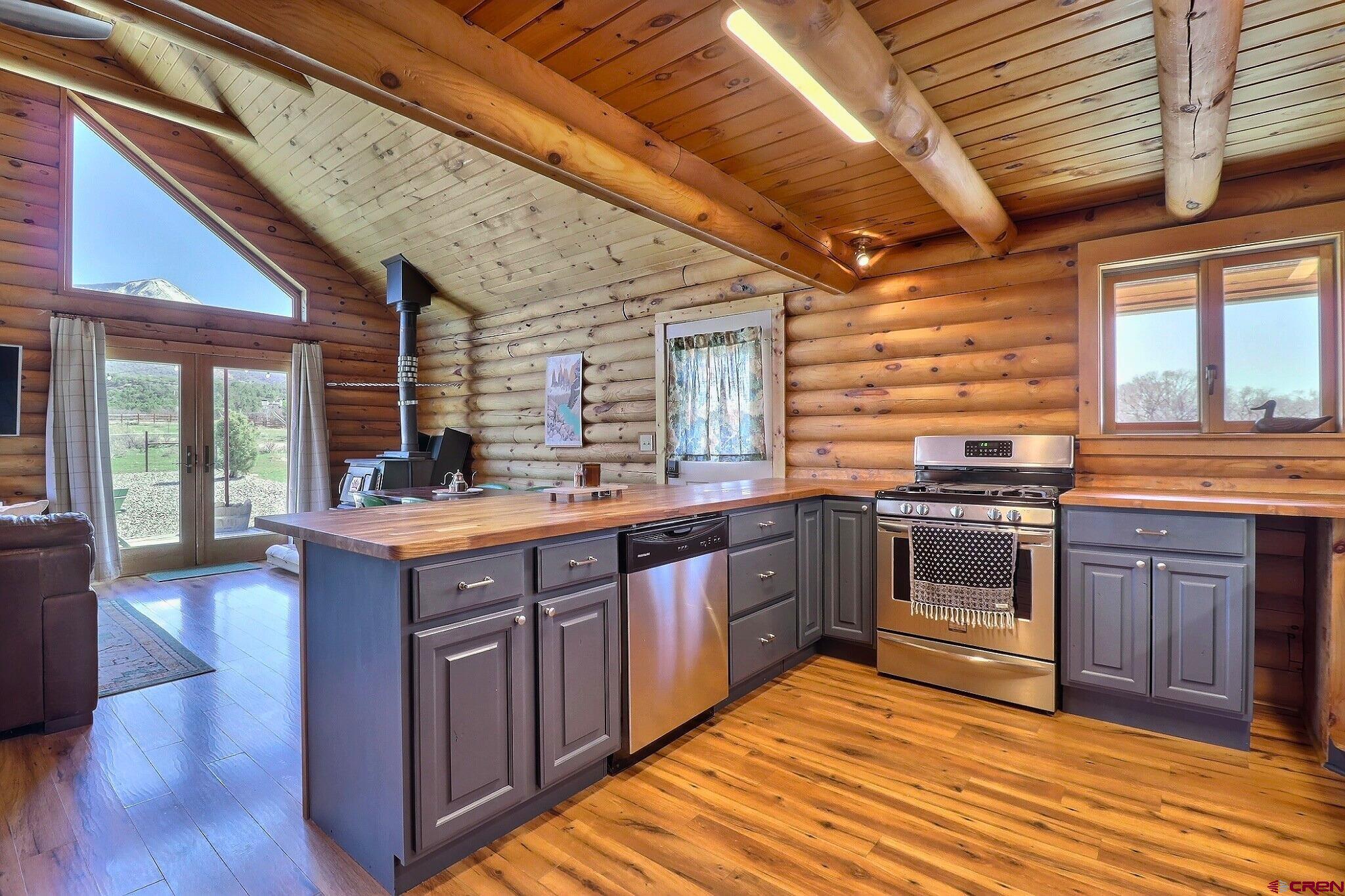 11531 4050th Road Paonia, CO 81428 - Photo 5 of 37 a kitchen with stainless steel appliances granite countertop wooden floors and sink