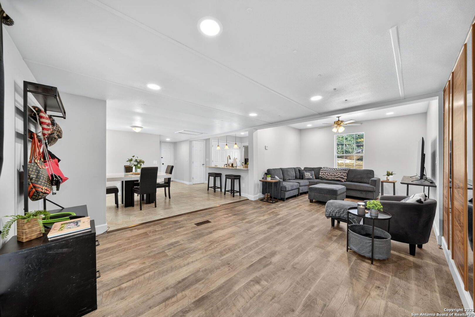 a living room with furniture and wooden floor