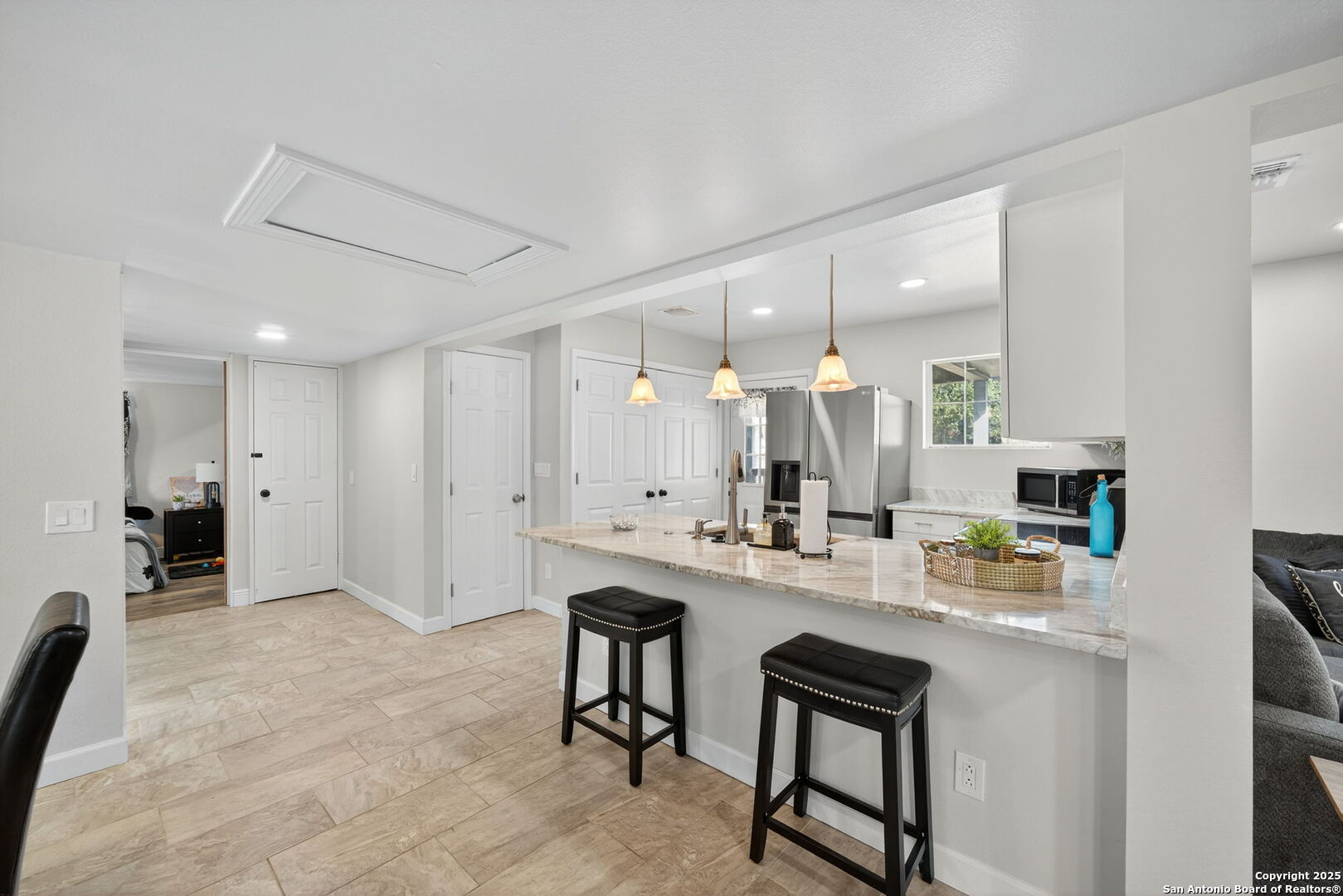 974 South Addison Street San Antonio, TX 78264 - Photo 12 of 37 a kitchen with kitchen island a sink table and chairs