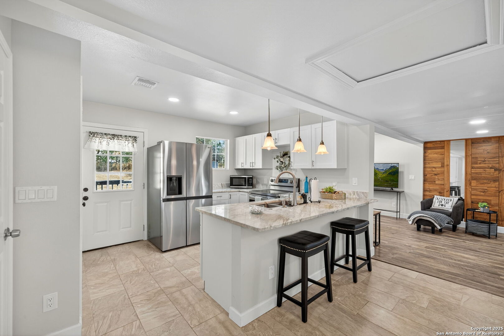974 South Addison Street San Antonio, TX 78264 - Photo 14 of 37 a kitchen with a refrigerator a stove a dining table and chairs