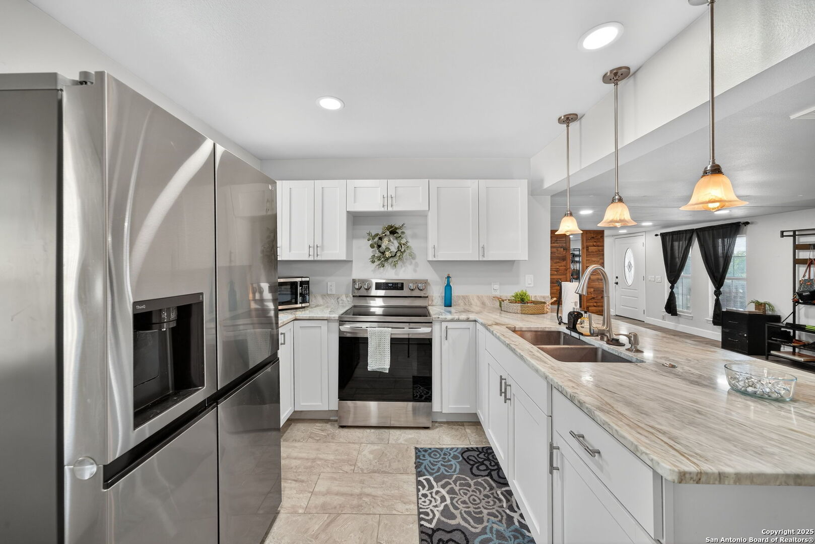 974 South Addison Street San Antonio, TX 78264 - Photo 15 of 37 a large kitchen with stainless steel appliances granite countertop a stove a sink and a refrigerator