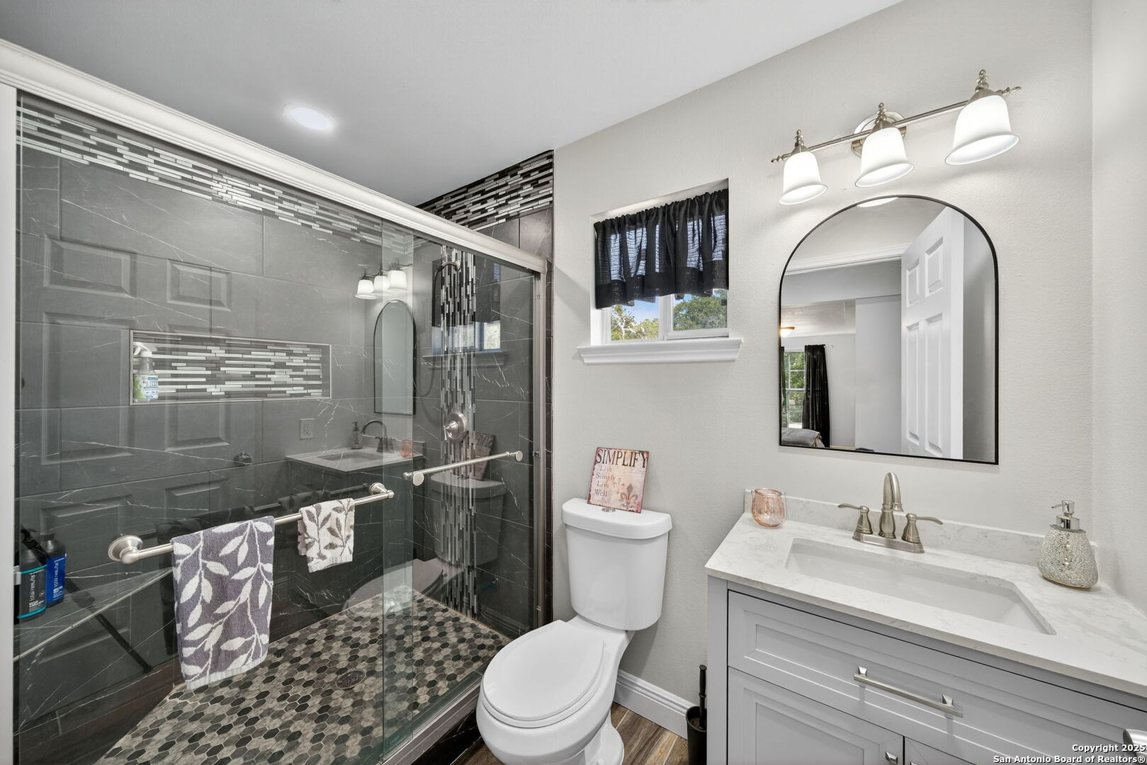 974 South Addison Street San Antonio, TX 78264 - Photo 18 of 37 a bathroom with a granite countertop sink mirror vanity and toilet